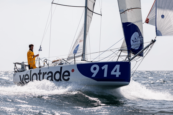 A full stern shot of the Velotrade sailboat with the skipper on board while sailing through Mini Transat Leg 1.
